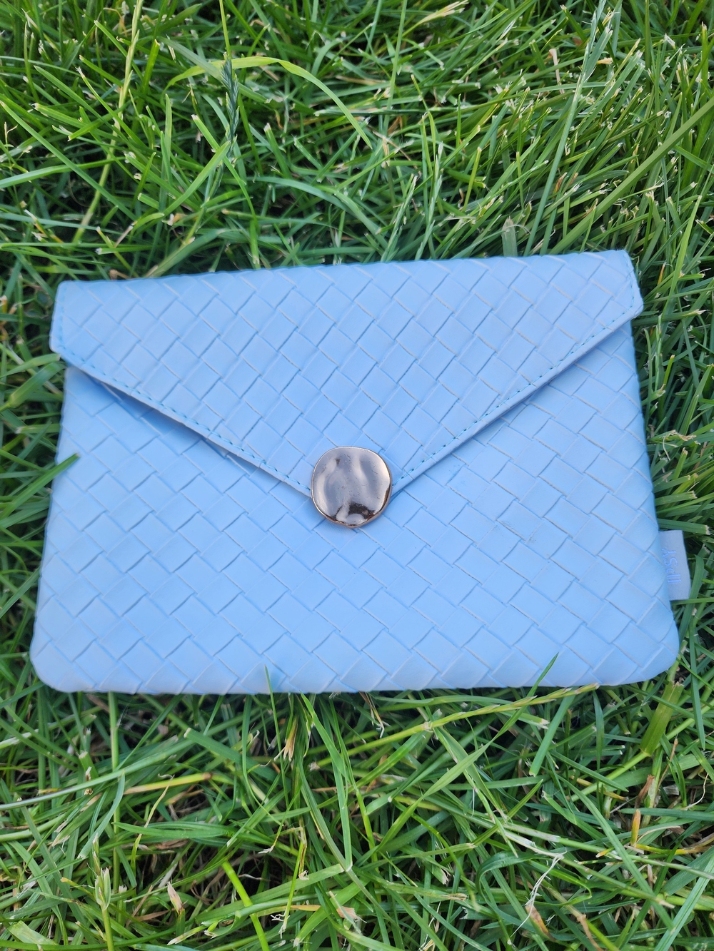 Ipsy Glam Bag from January 2025 featuring a light blue woven design